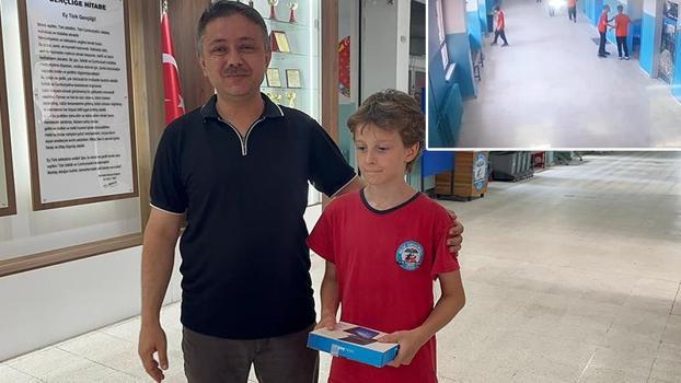 Okul koridorundaki çöpü kutuya atarken görüntülenen öğrenciye tablet hediyesi