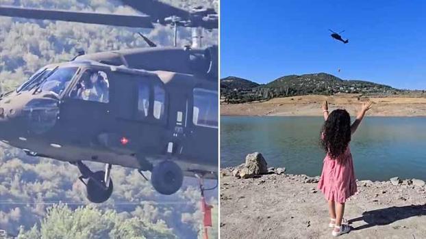 Yangına müdahale eden askeri helikopterin pilotu, kendisini selamlayan çocuğa el salladı