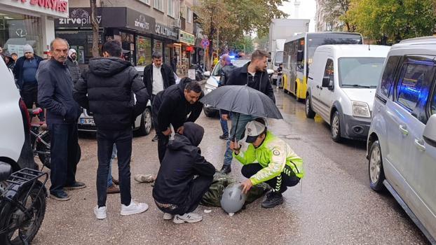Kadın polis, yaralı ıslanmasın diye başında şemsiyeyle bekledi