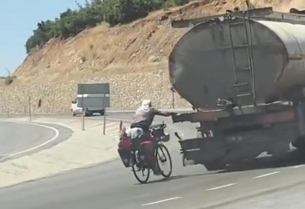 Tankere tutunup yolculuk yapan bisikletli kamerada