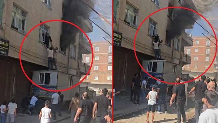 Yangında mahsur kalan kadını konteynerin üzerine çıkarak kurtardılar
