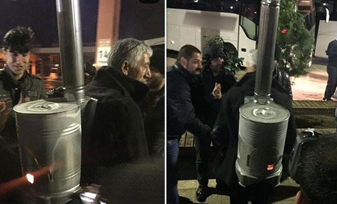 Sırtında yanan odun sobasıyla sokaklarda gezintiye çıktı