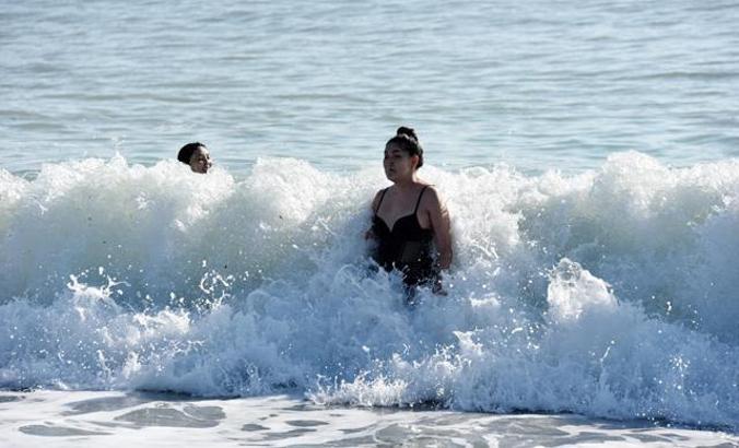Tourists enjoyed swimming on the first day of the year in Antalya