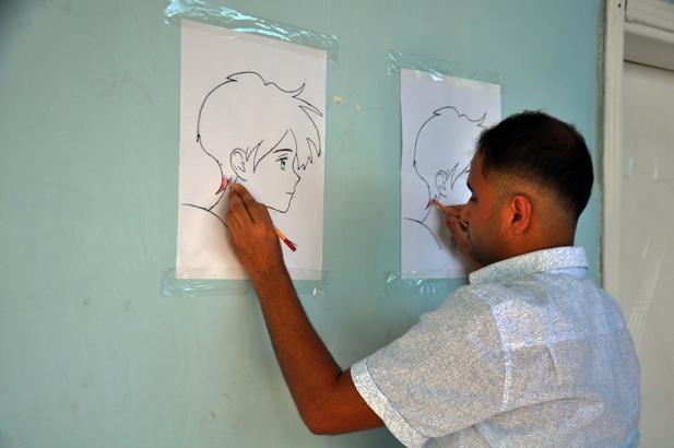 İki eliyle aynı anda iki resim çiziyor