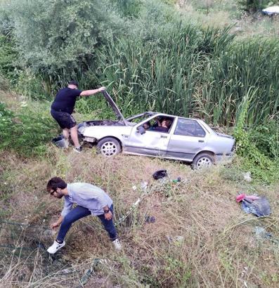 Dere yatağına devrilen otomobildeki 2 kişi yaralandı