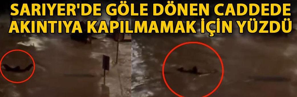 Sarıyer'de göle dönen caddede akıntıya kapılmamak için yüzdü