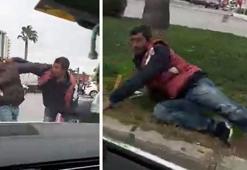 Madde bağımlıları, ışıkta bekleyen otomobillerin camını silmek için yumruk yumruğa kavga etti