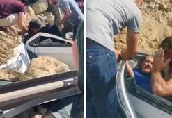 Kamyon üstüne devrildi; hafriyat altında kalan otomobildeki sürücüyü kurtardılar