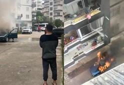 Yanan araca, balkondan kova ile su dökerek müdahale etti