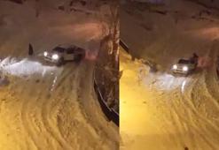 Buz pistine dönen yolda kayan kamyonetin altında kalmaktan son anda kurtuldu; olay anı kamerada