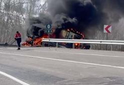 TIR devrildi, üzerindeki iş makinesi alev aldı; 3 yaralı