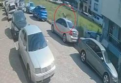 Sokak köpeklerinden kaçmak isterken başını park halindeki otomobile çarptı; o anlar kamerada