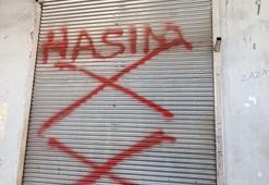 Dükkanının kepengine 'hasım' yazan kişiyi tabancayla bacağından vurdu