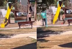 Sıcak havada parkta oynayan çocukları hortumla su sıkarak serinletti