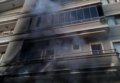Binada çıkan yangında 2'nci katın balkonundan düşüp yaralandı
