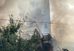 Depoda çıkan yangını kovayla su döküp söndürmeye çalıştı