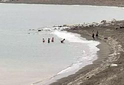 Yüksek kesimlerine kar yağan Bitlis'te, göle girip yüzdüler