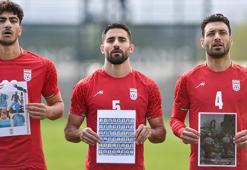 FIFA Başkanı Infantıno’nun izlediği maçta, İran Milli Takımı sahaya öldürülen çocukların fotoğraflarıyla çıktı