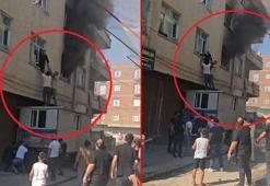 Yangında mahsur kalan kadını konteynerin üzerine çıkarak kurtardılar