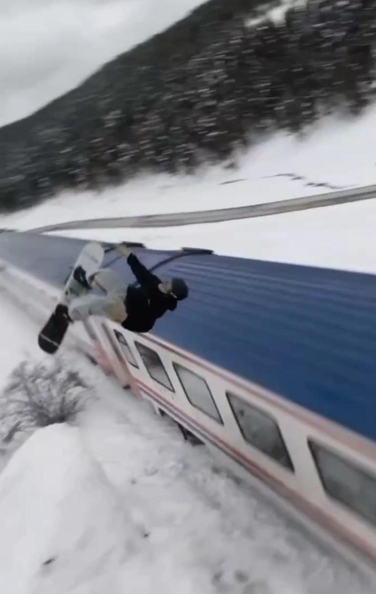 Snowboardla trenin üzerinden atladı