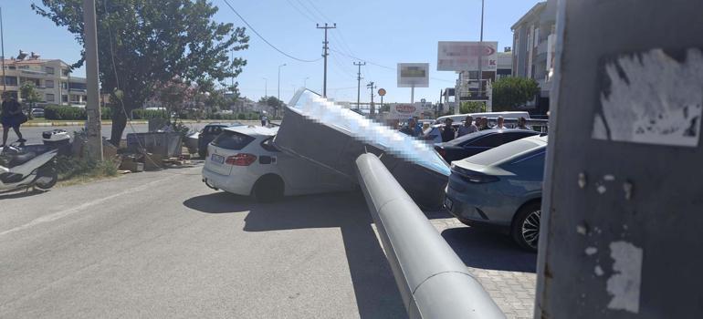 Üzerine reklam totemi devrilen otomobilin sürücüsü yara almadan kurtuldu